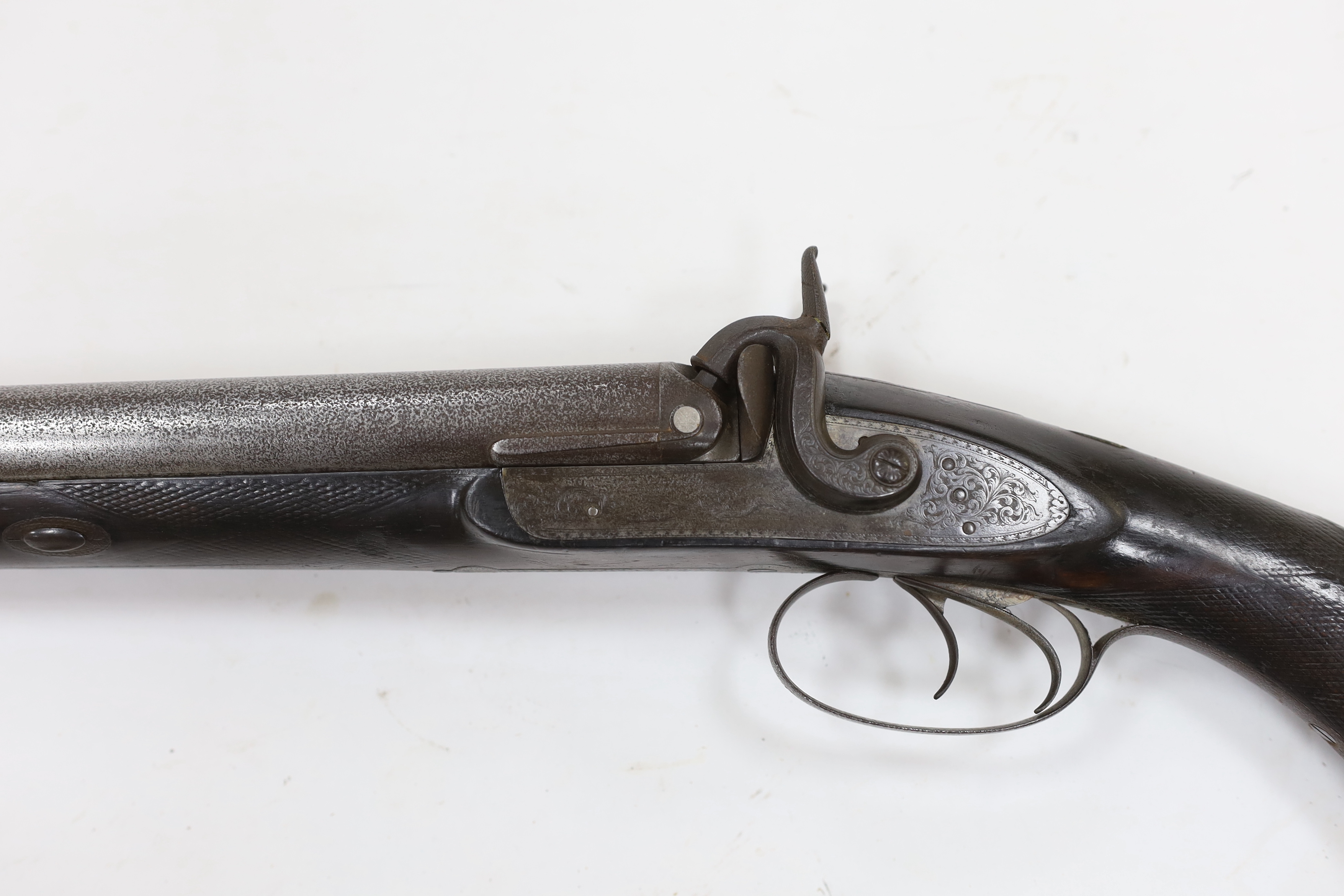A double barrel, percussion sporting gun by F.T. Baker, half stocked, locks engraved with gundogs, iron mounts, barrels 74cm